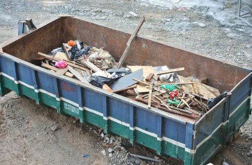 Crew wearing PPE preparing a skip for collection